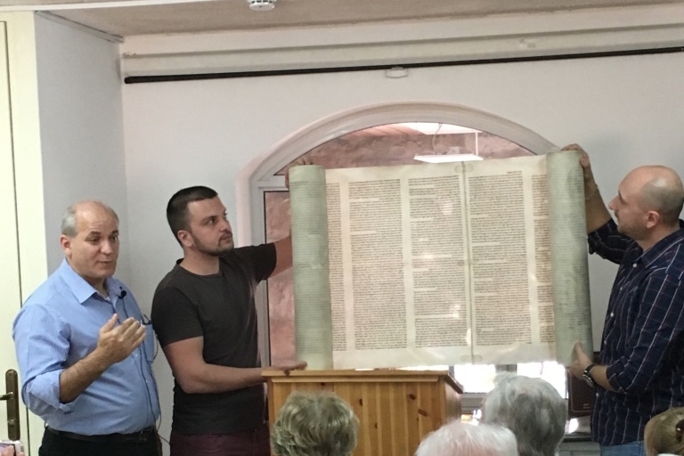 torah scroll unrolled for visitors to Bible Society of Israel