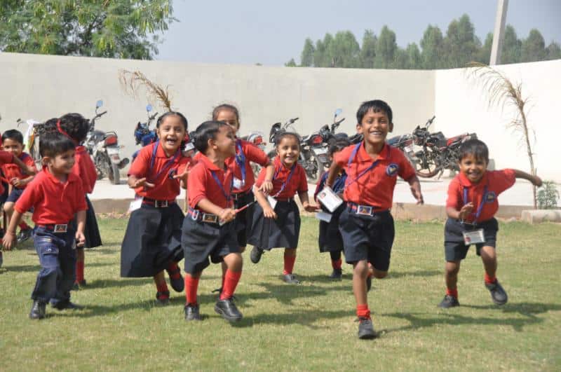 children in school in rural india play in the yard