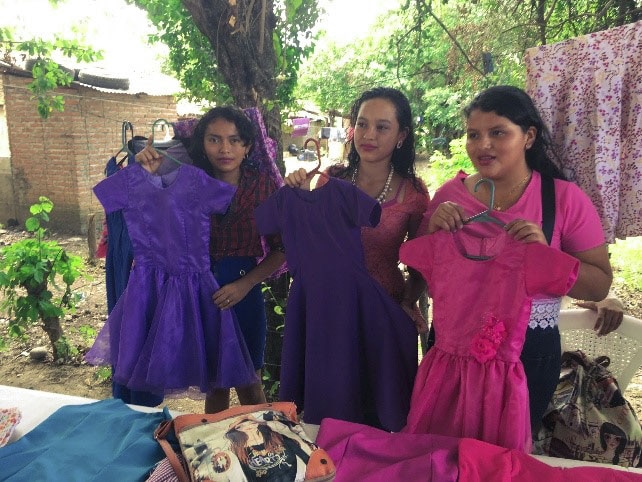 honduran students present clothes they have made at Renacer sewing school