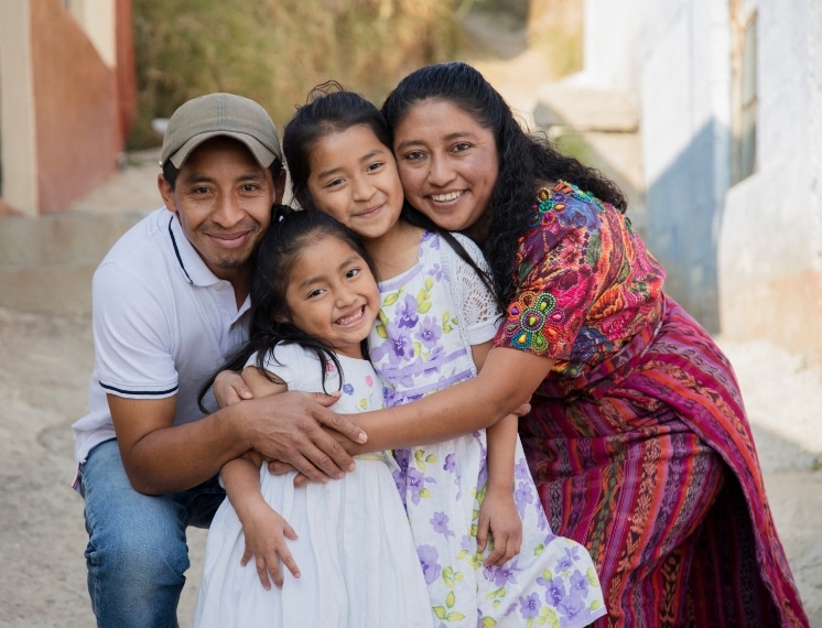 A family smiles in the streets of Mexico