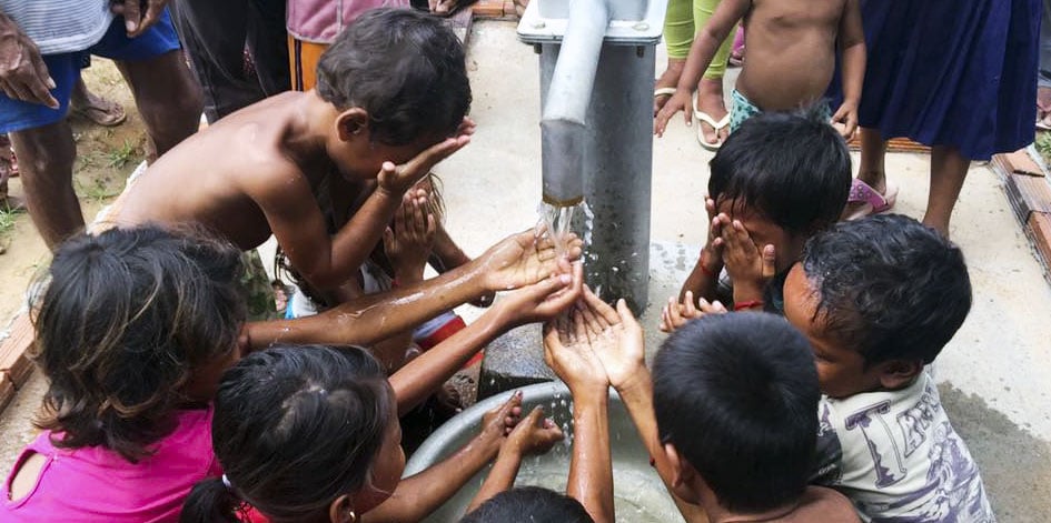 Children gathered around a well built by Sokhon and Esther’s ministry in Cambodia
